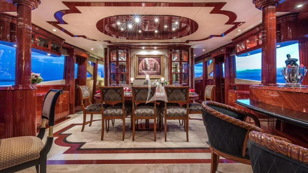 a room with a table chairs and a piano aboard CEDAR ISLAND Yacht for Sale