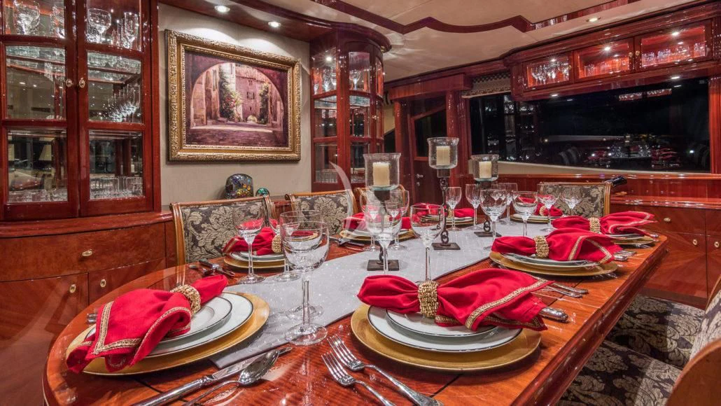 a table with plates and glasses aboard CEDAR ISLAND Yacht for Sale