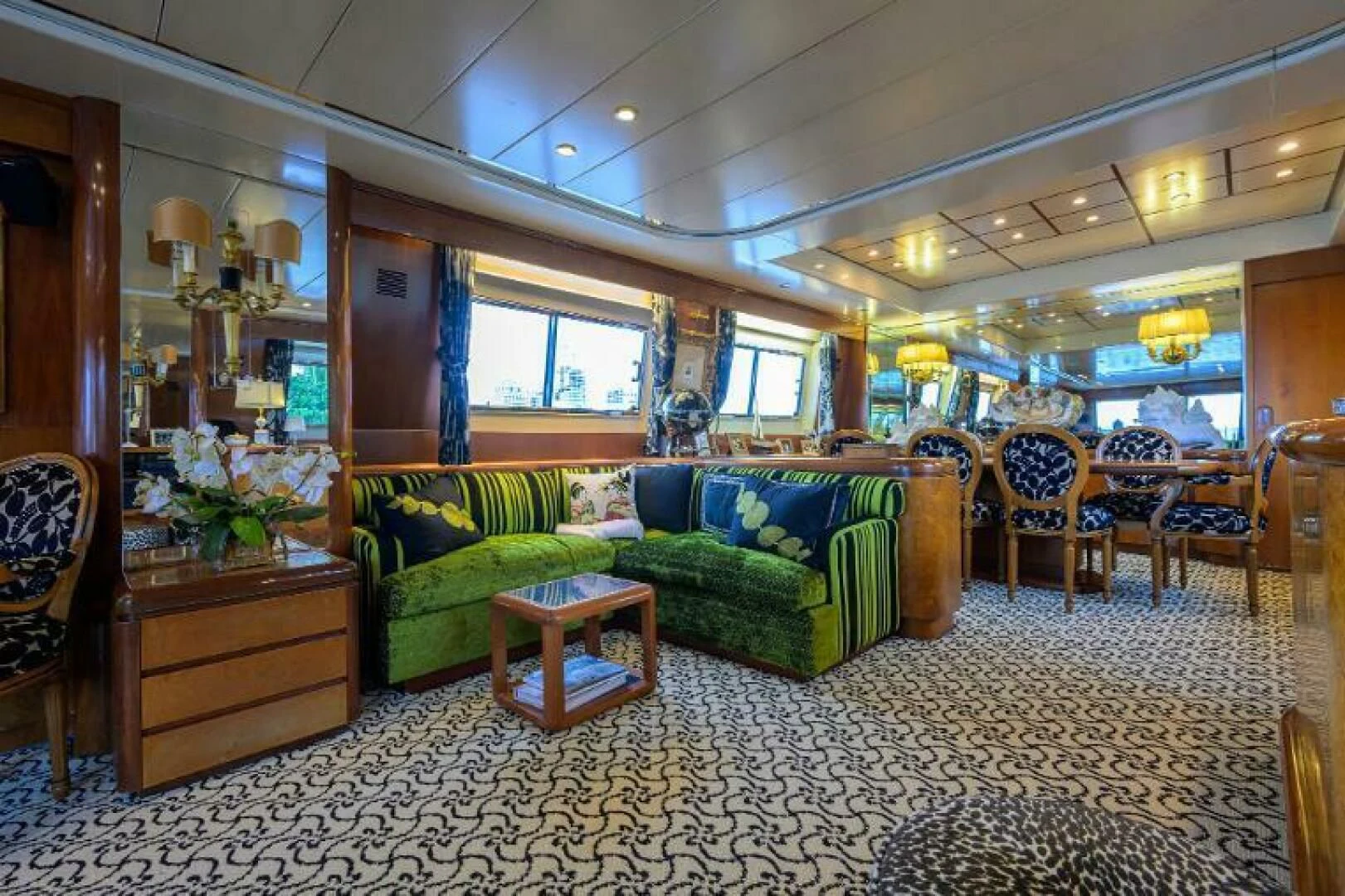 a living room with a couch and a table aboard CIPANGO Yacht for Sale