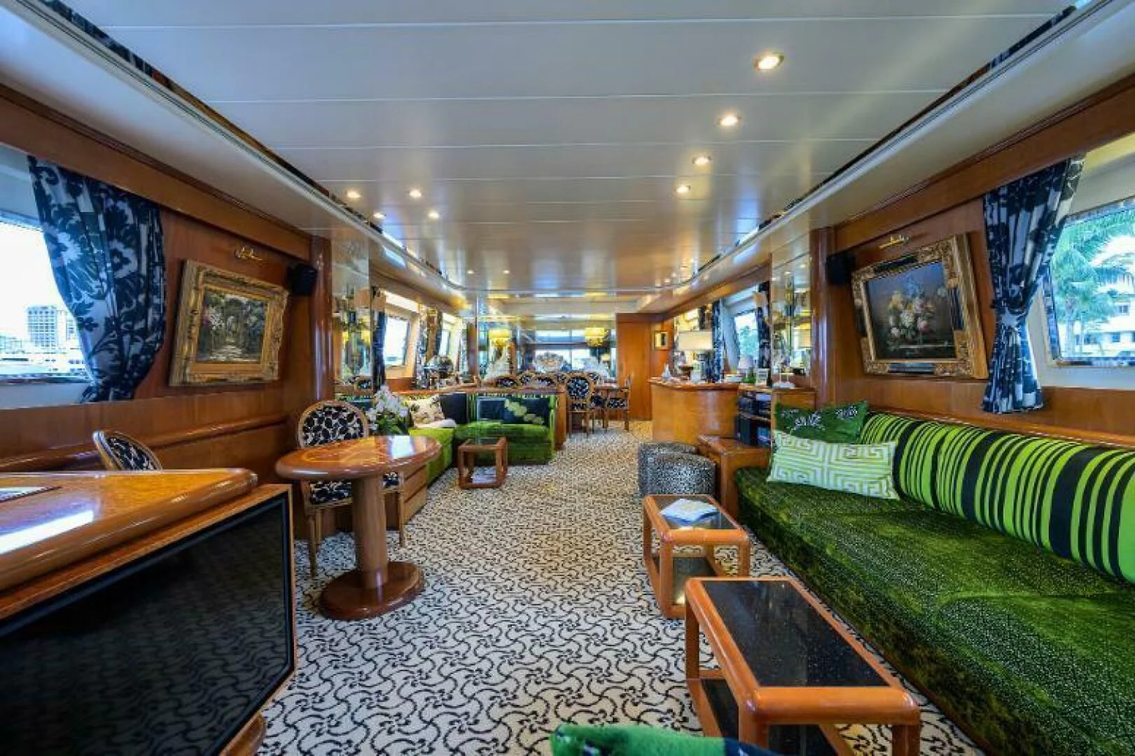 a living room with a couch and a table aboard CIPANGO Yacht for Sale