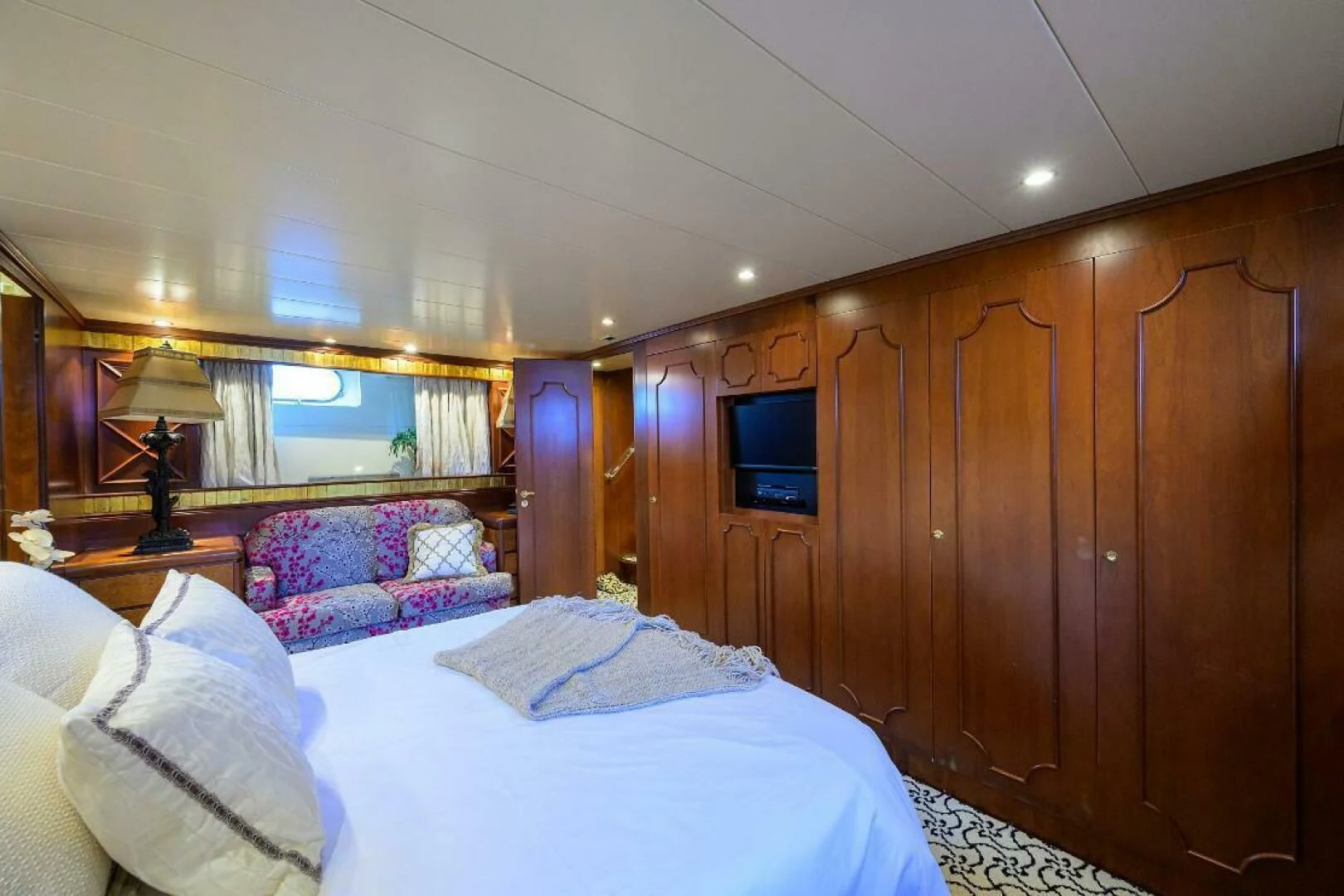 a room with a bed and a television aboard CIPANGO Yacht for Sale