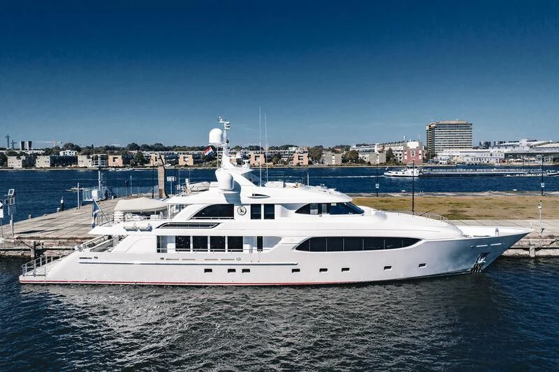 a white yacht in a harbor aboard ARCTIC PRIDE II Yacht for Sale