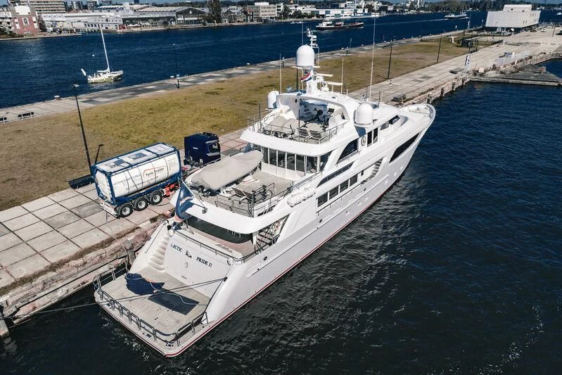 a large white boat docked at a pier aboard ARCTIC PRIDE II Yacht for Sale