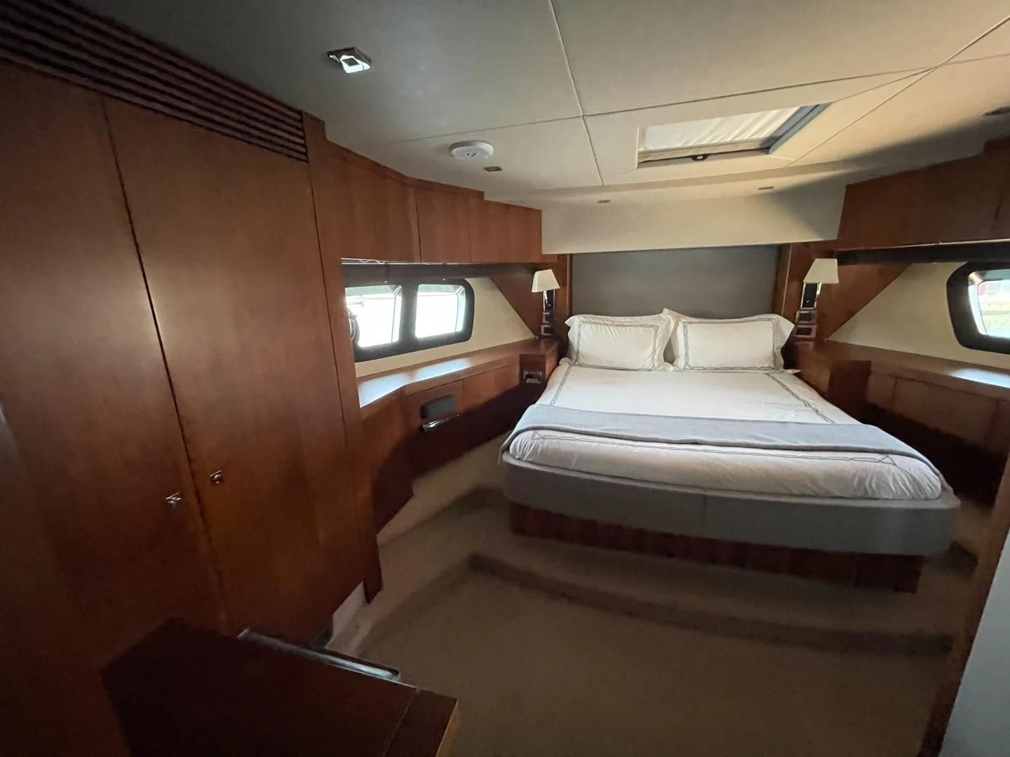 a room with a bed and a window aboard TRAINERA Yacht for Sale