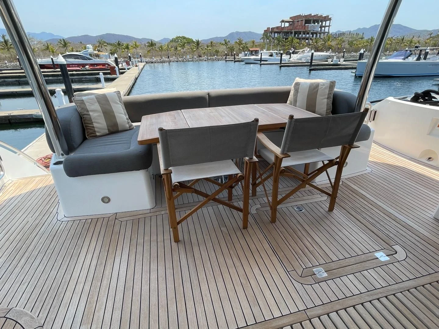 a deck with chairs and a table on it aboard TRAINERA Yacht for Sale