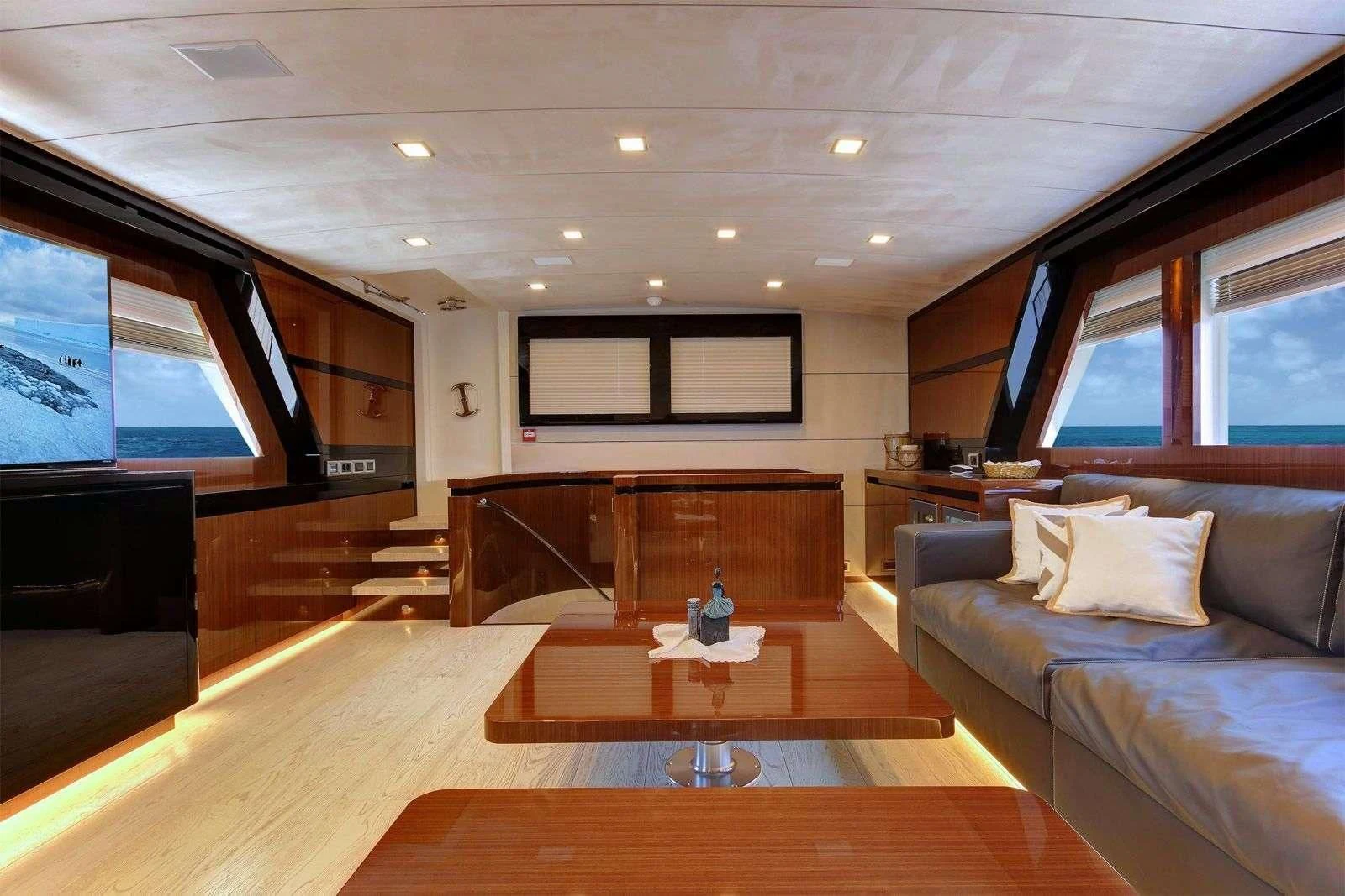 a living room with a large screen aboard MOSS Yacht for Sale