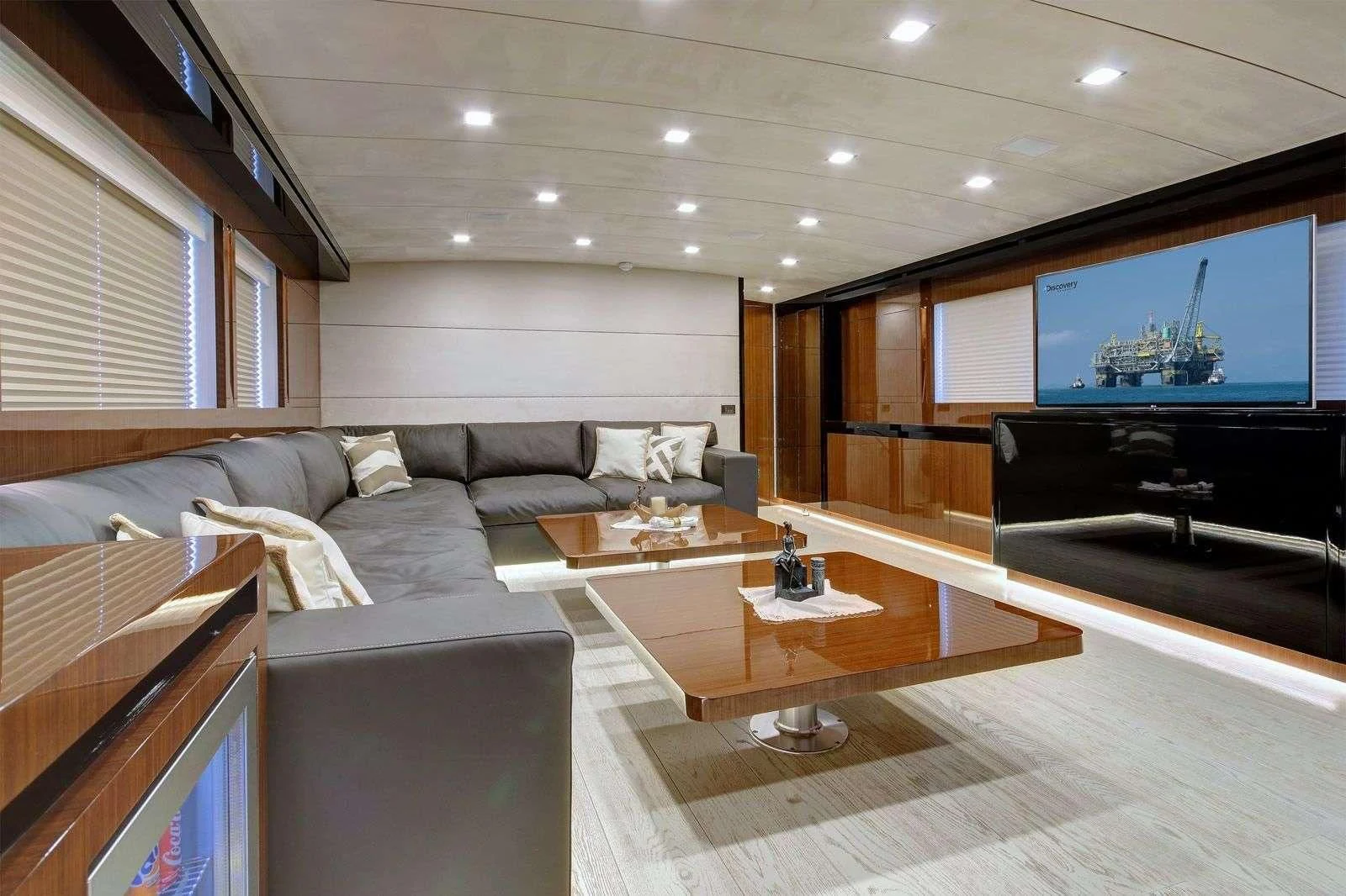 a living room with a large screen aboard MOSS Yacht for Sale