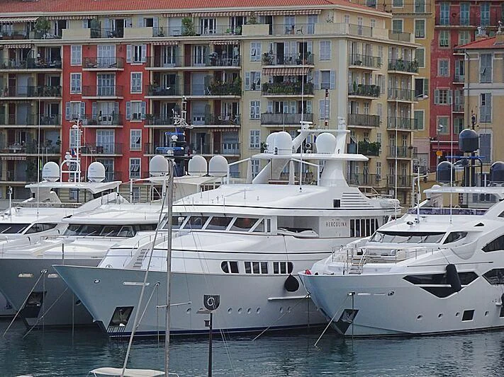 a couple of boats sit in a harbor aboard HERCULES Yacht for Sale