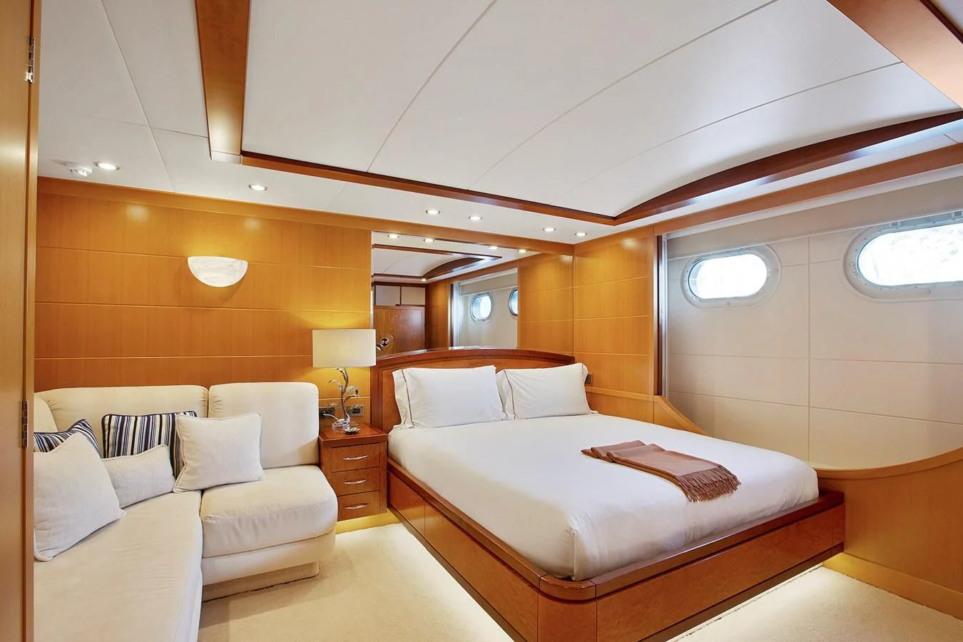 a room with a bed and a lamp aboard HERCULES Yacht for Sale