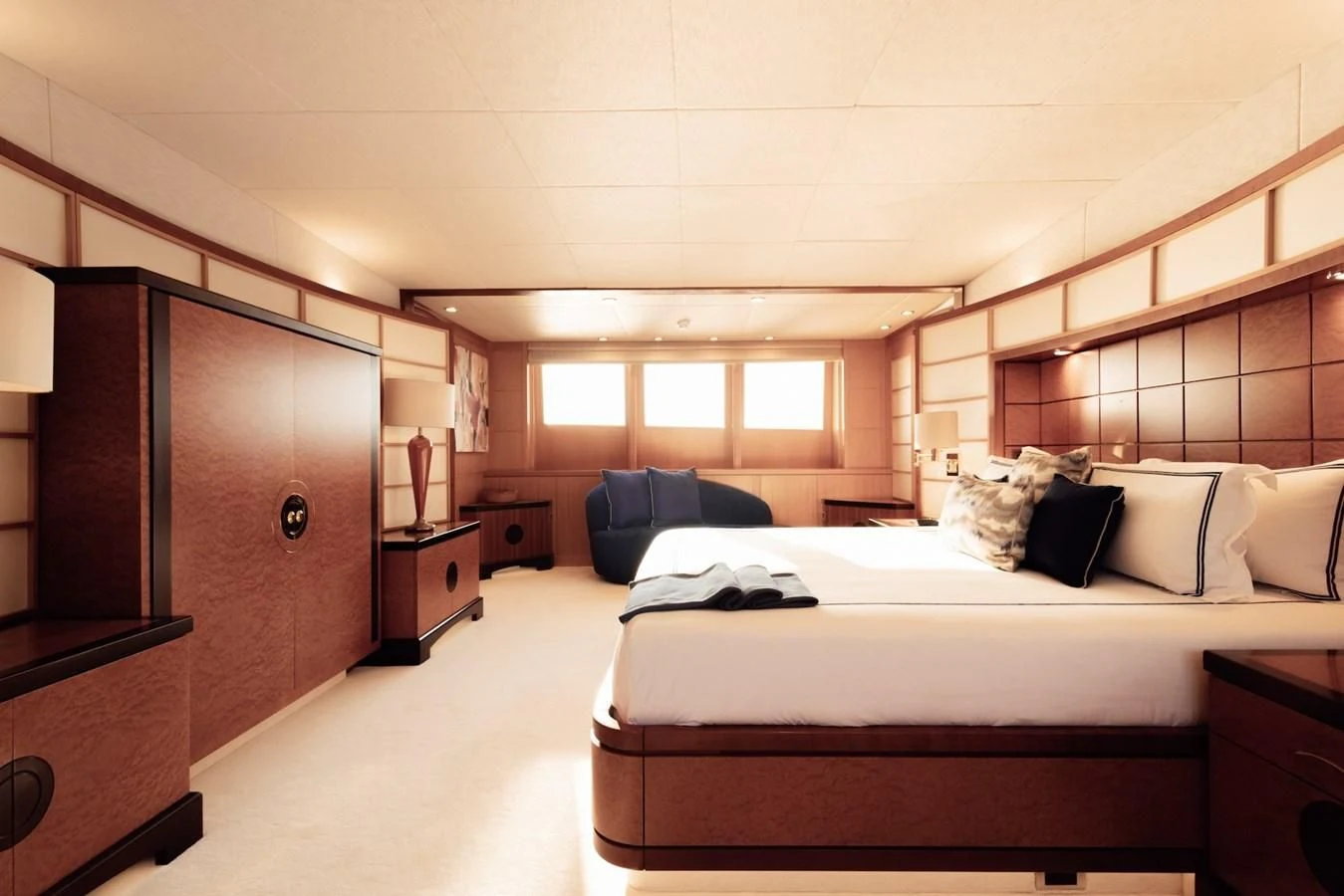 a bedroom with a bed and a couch aboard HERCULES Yacht for Sale