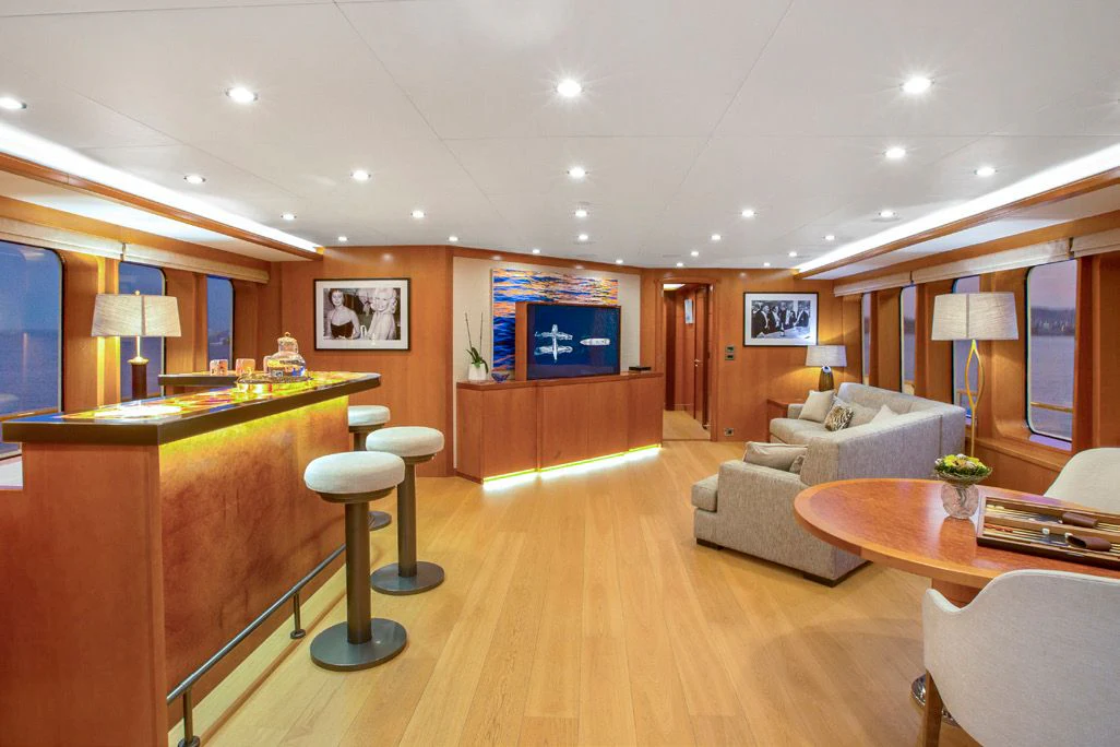 a living room with a couch and a table aboard HERCULES Yacht for Sale