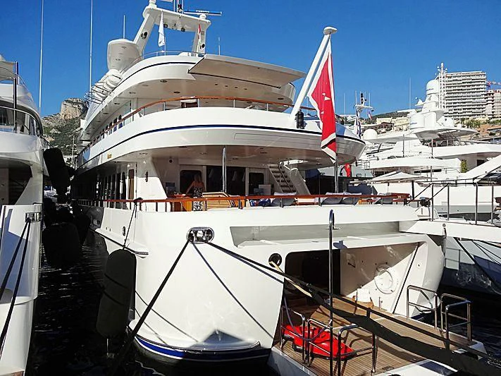 a large white boat with flags on it aboard HERCULES Yacht for Sale