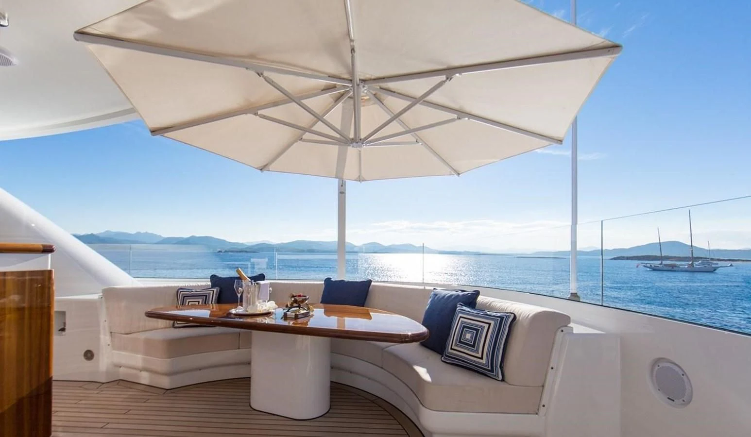 a room with a couch and a table and a large body of water aboard HERCULES Yacht for Sale