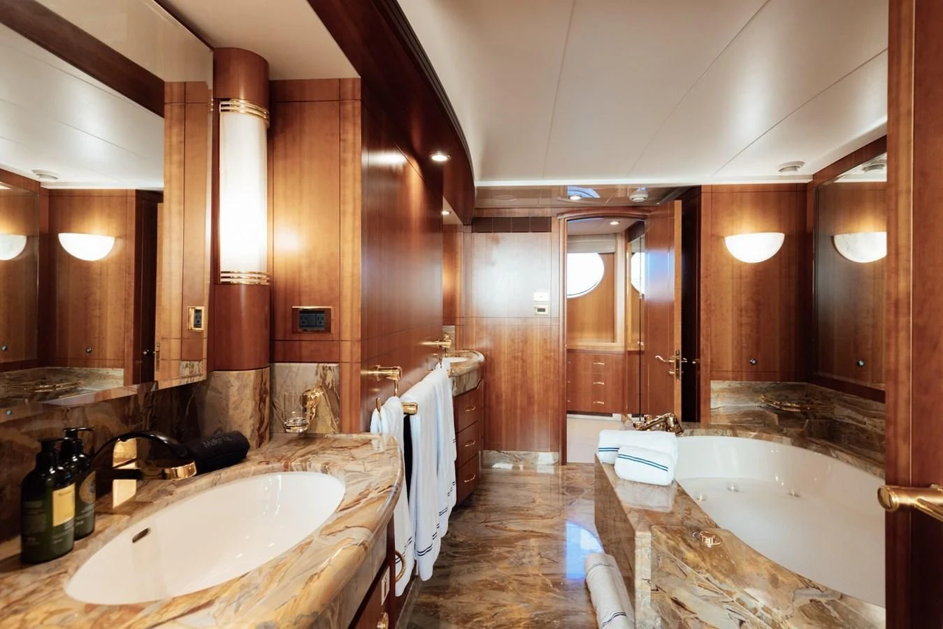 a bathroom with a tub sink and a sink aboard HERCULES Yacht for Sale