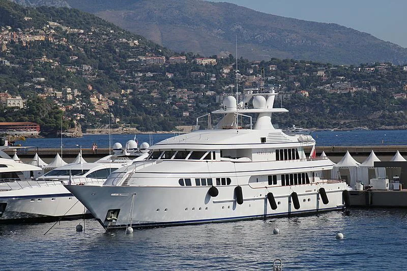 a large white boat in a harbor aboard HERCULES Yacht for Sale