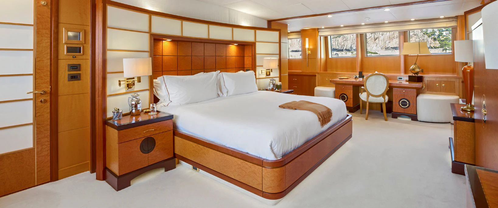 a room with a bed and desk aboard HERCULES Yacht for Sale