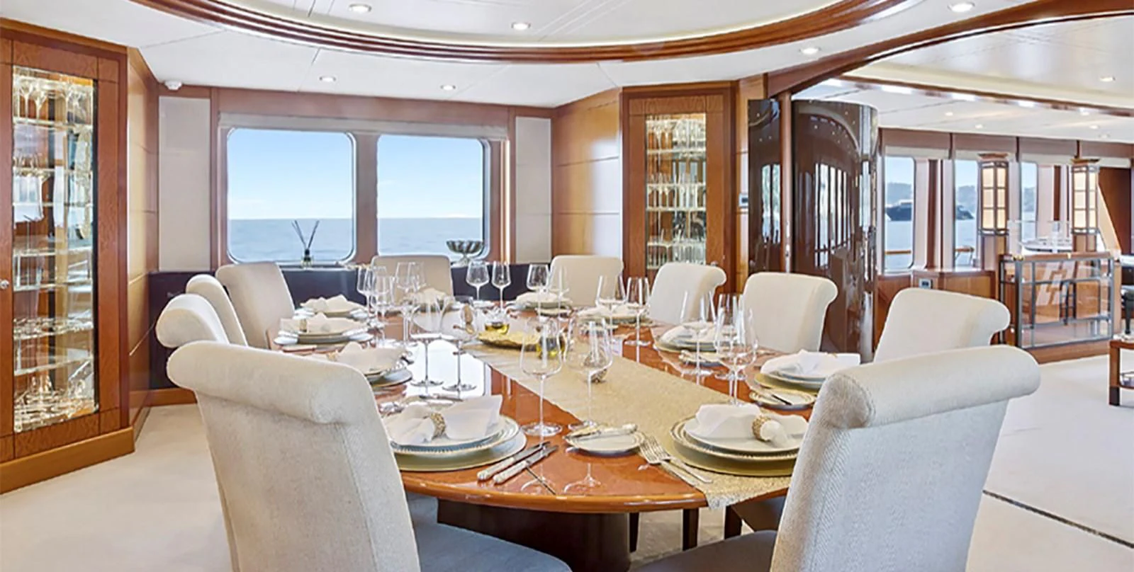 a dining room with a table set for a meal aboard HERCULES Yacht for Sale