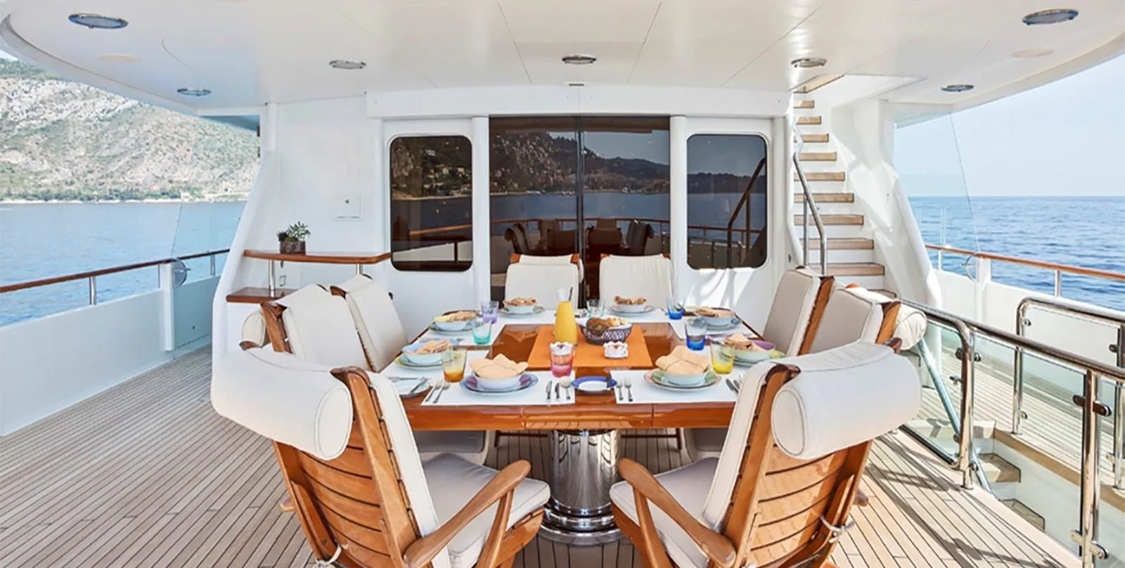 a table with chairs and a table on a boat aboard HERCULES Yacht for Sale
