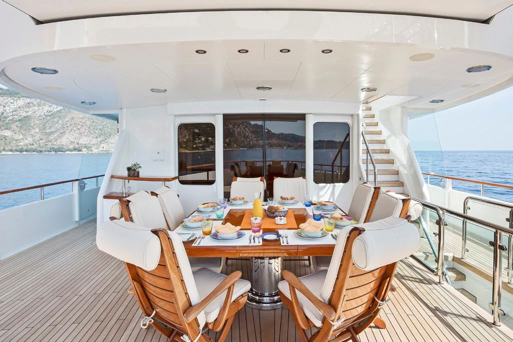 a boat with a table and chairs aboard HERCULES Yacht for Sale