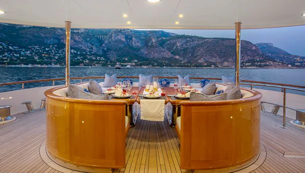 a table with chairs on it aboard HERCULES Yacht for Sale