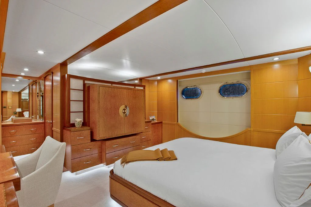 a room with a bed and a mirror aboard HERCULES Yacht for Sale