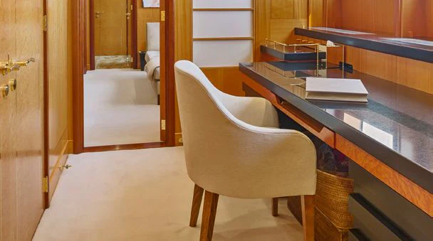 a chair and a table in a room aboard HERCULES Yacht for Sale