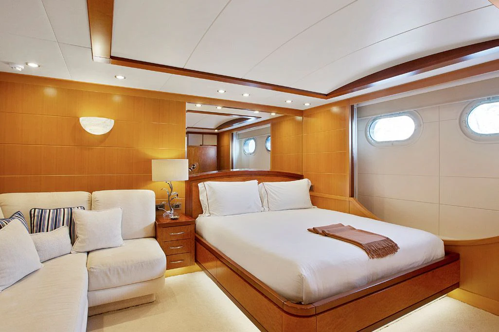 a room with a bed and a couch aboard HERCULES Yacht for Sale