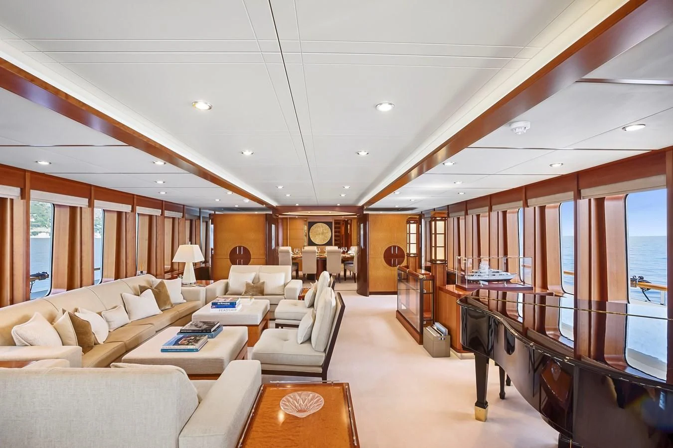 a large living room with a piano aboard HERCULES Yacht for Sale