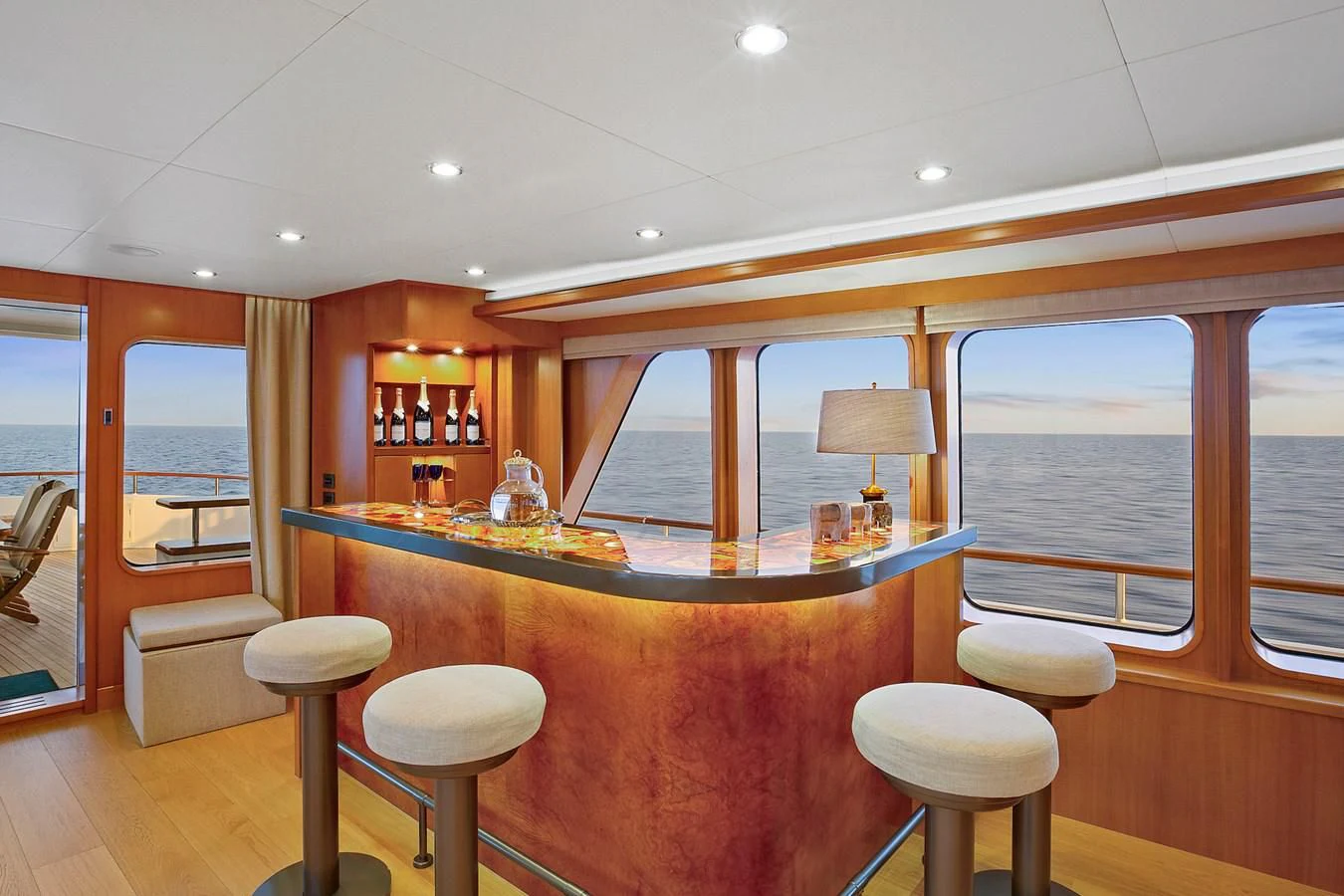 a large kitchen with a bar and bar stools aboard HERCULES Yacht for Sale
