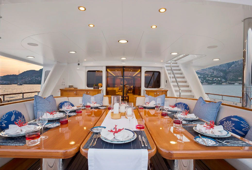 a large room with a table and chairs and a large window aboard HERCULES Yacht for Sale