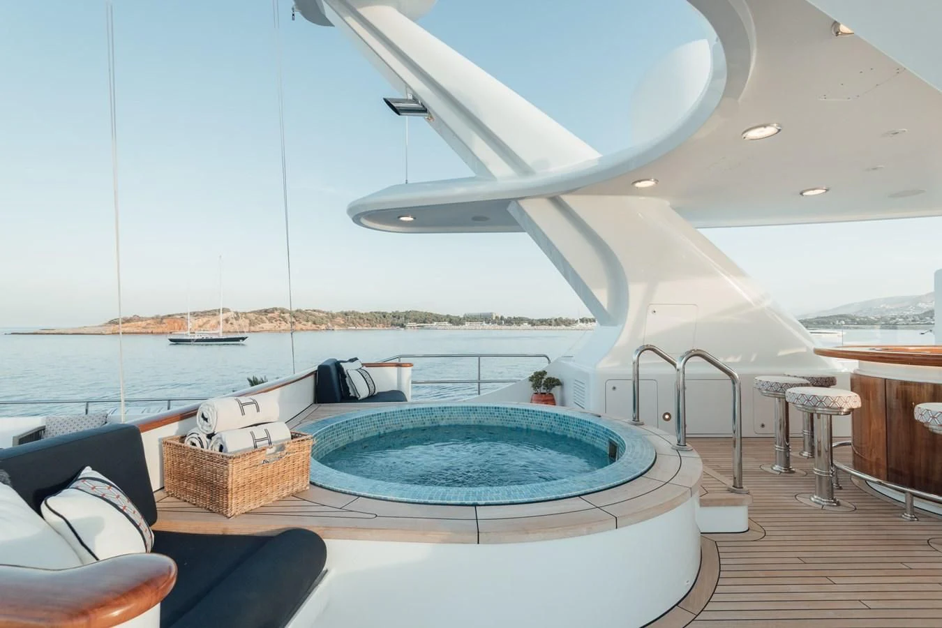 a large white lounge chair next to a pool with a large pool aboard HERCULES Yacht for Sale