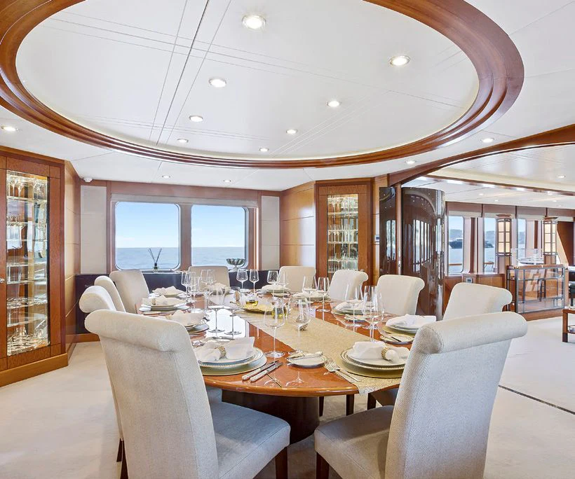 a large dining room with a large table and chairs aboard HERCULES Yacht for Sale