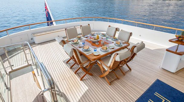 a table set for a meal on a boat aboard HERCULES Yacht for Sale