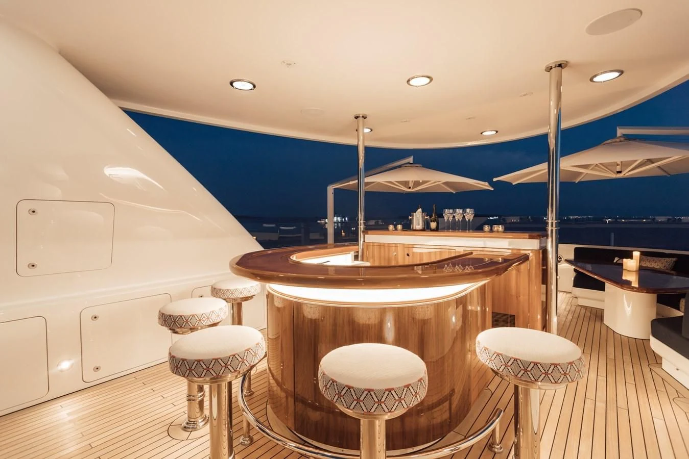 a large kitchen with a bar and stools aboard HERCULES Yacht for Sale