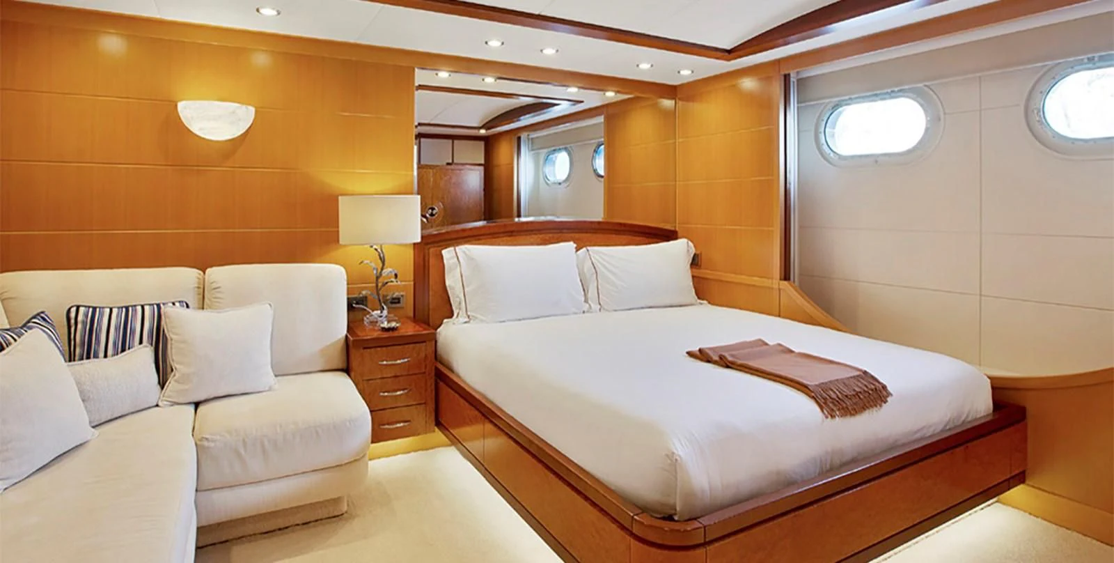 a room with a bed and a couch aboard HERCULES Yacht for Sale