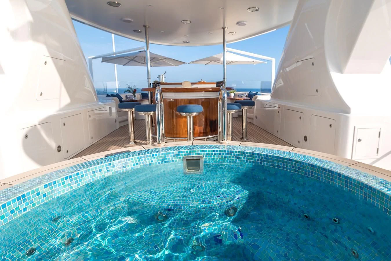 a swimming pool with a chair and a table and chairs aboard HERCULES Yacht for Sale