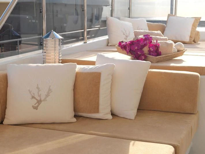 a couch with pillows and flowers aboard EILEEN Yacht for Sale