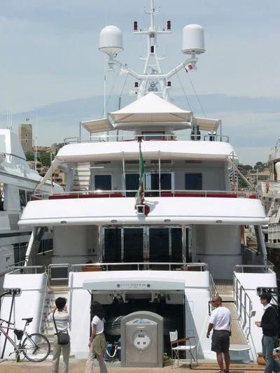 a large white boat with a green stripe on it aboard EILEEN Yacht for Sale