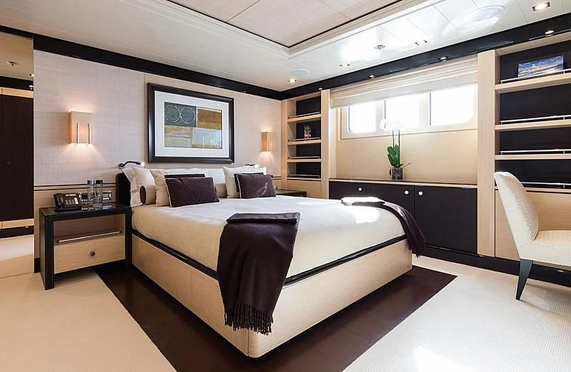a bedroom with a bed and a desk aboard GRACE (YET) Yacht for Sale