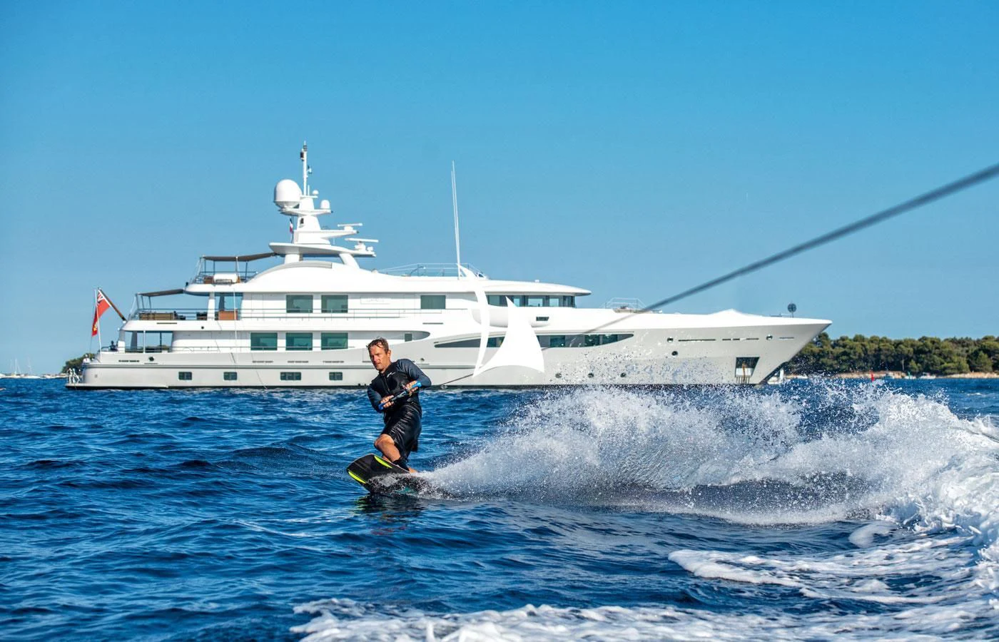 a man surfing in the sea aboard GRACE (YET) Yacht for Sale
