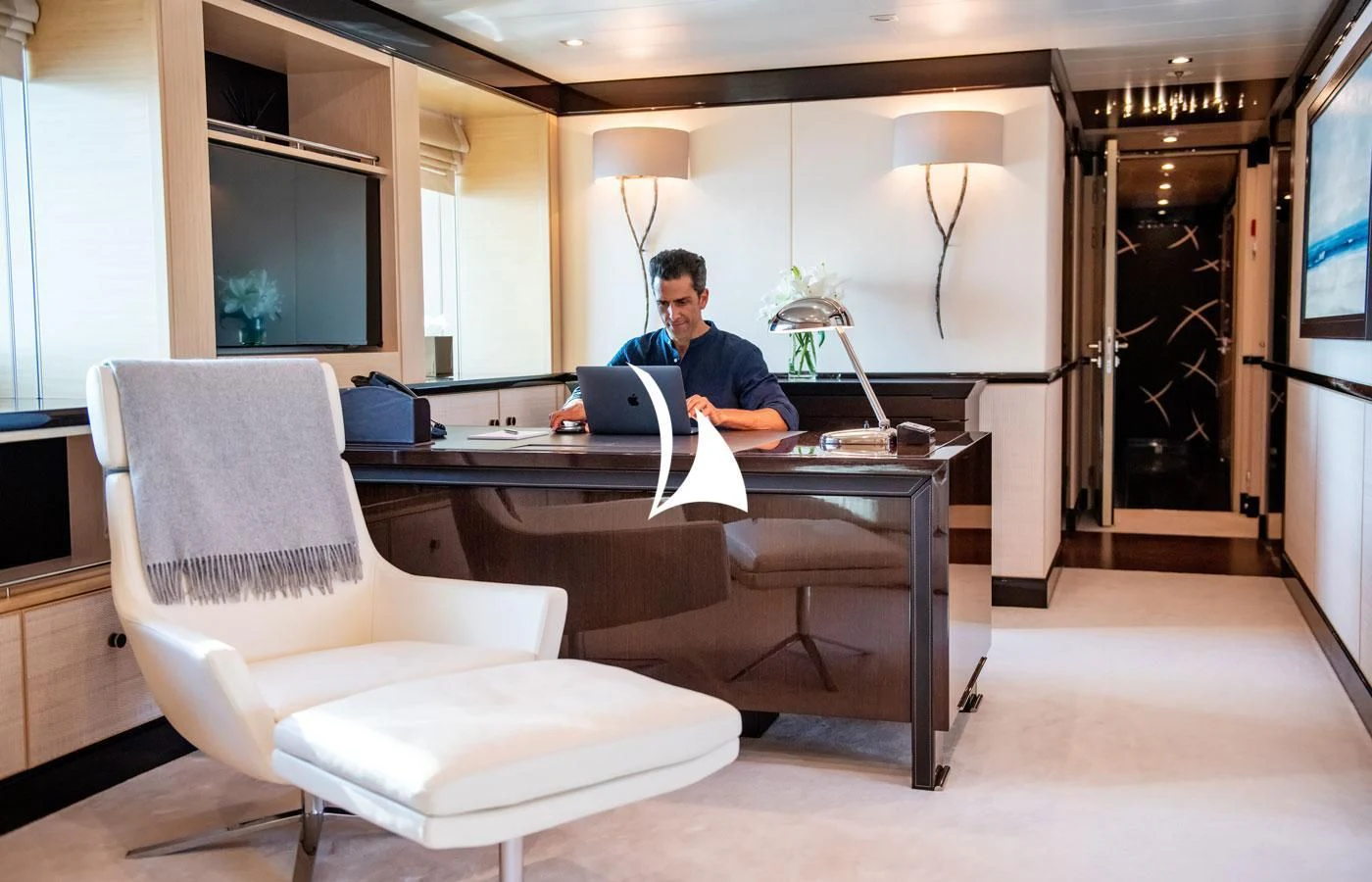 a person sitting at a desk aboard GRACE (YET) Yacht for Sale