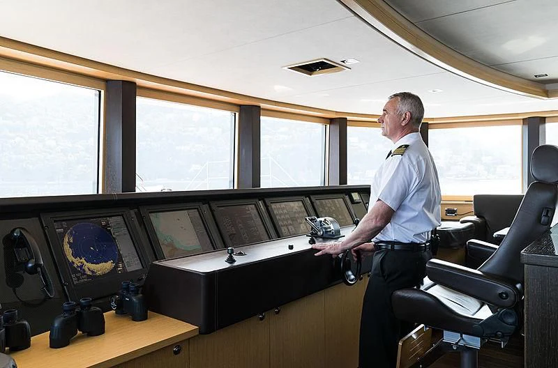 a person standing in front of a computer aboard GRACE (YET) Yacht for Sale