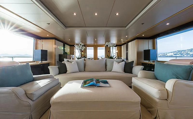 a living room with a large sofa and a large window aboard GRACE (YET) Yacht for Sale