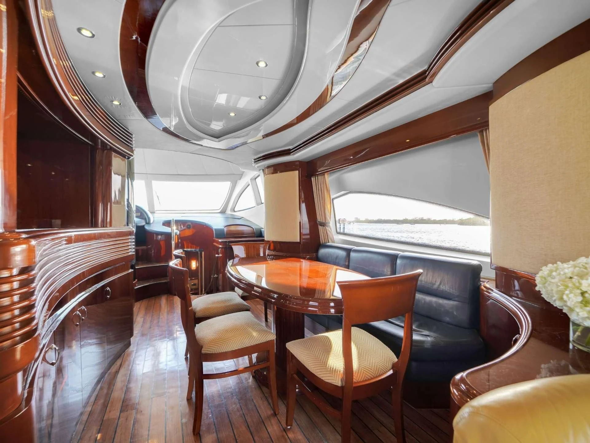 a dining room with a large window aboard DELMAR Yacht for Sale