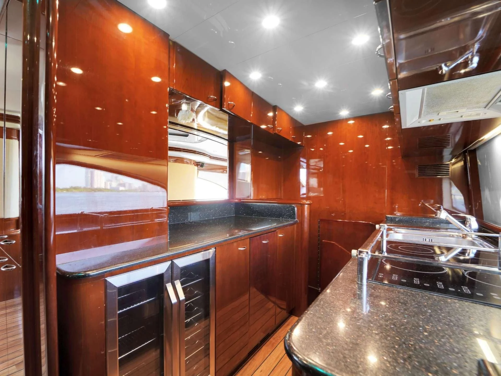 a kitchen with wooden cabinets aboard DELMAR Yacht for Sale
