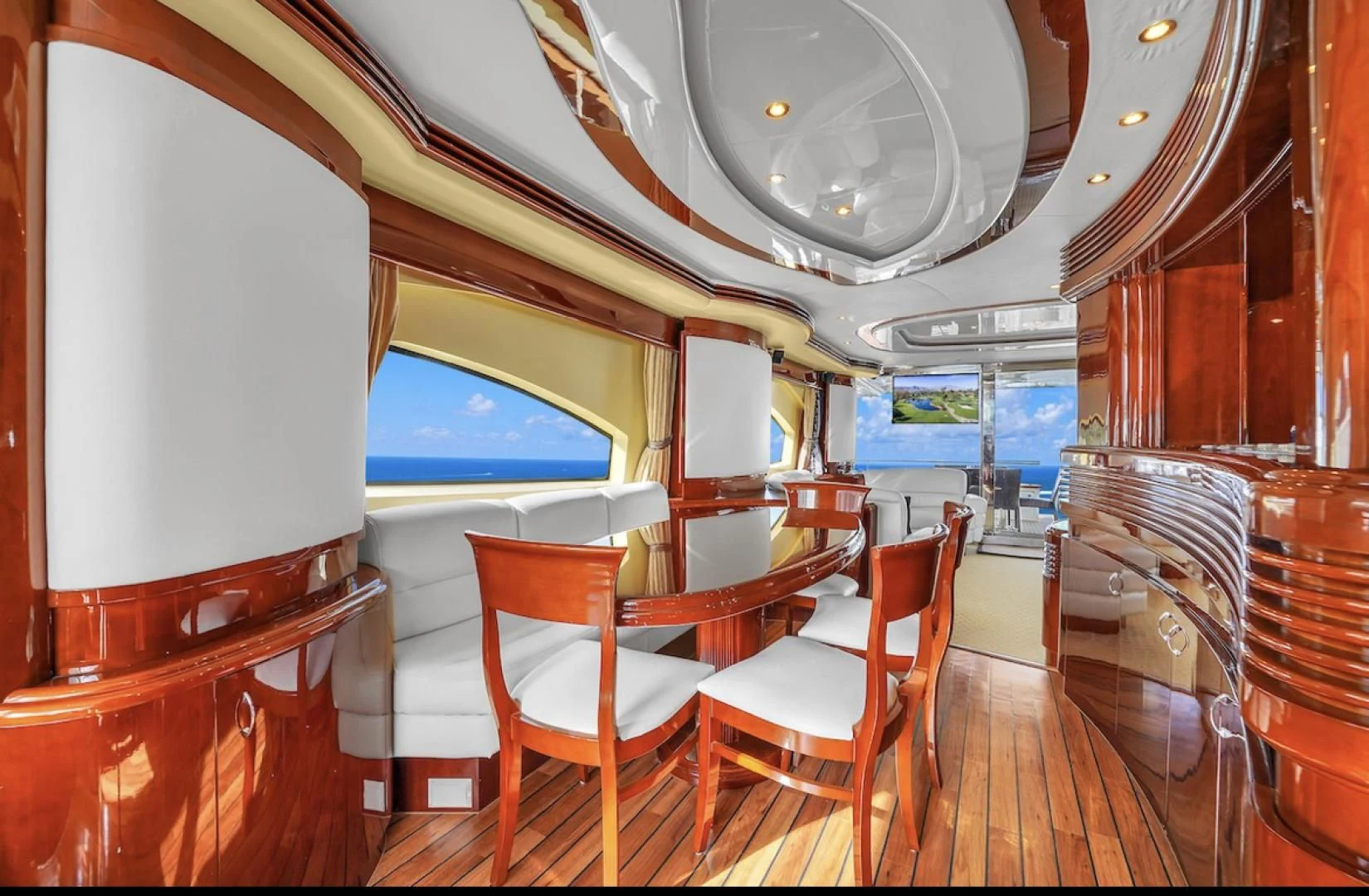 a room with tables and chairs aboard DELMAR Yacht for Sale