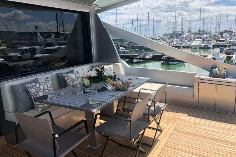 a room with a table and chairs aboard QUEEN B SPORT Yacht for Sale