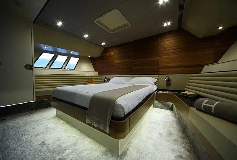 a room with a bed and a window aboard TACHION Yacht for Sale