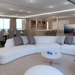 a living room with a couch and a table aboard SEA SEARCHER INDEPENDENCE 110 Yacht for Sale