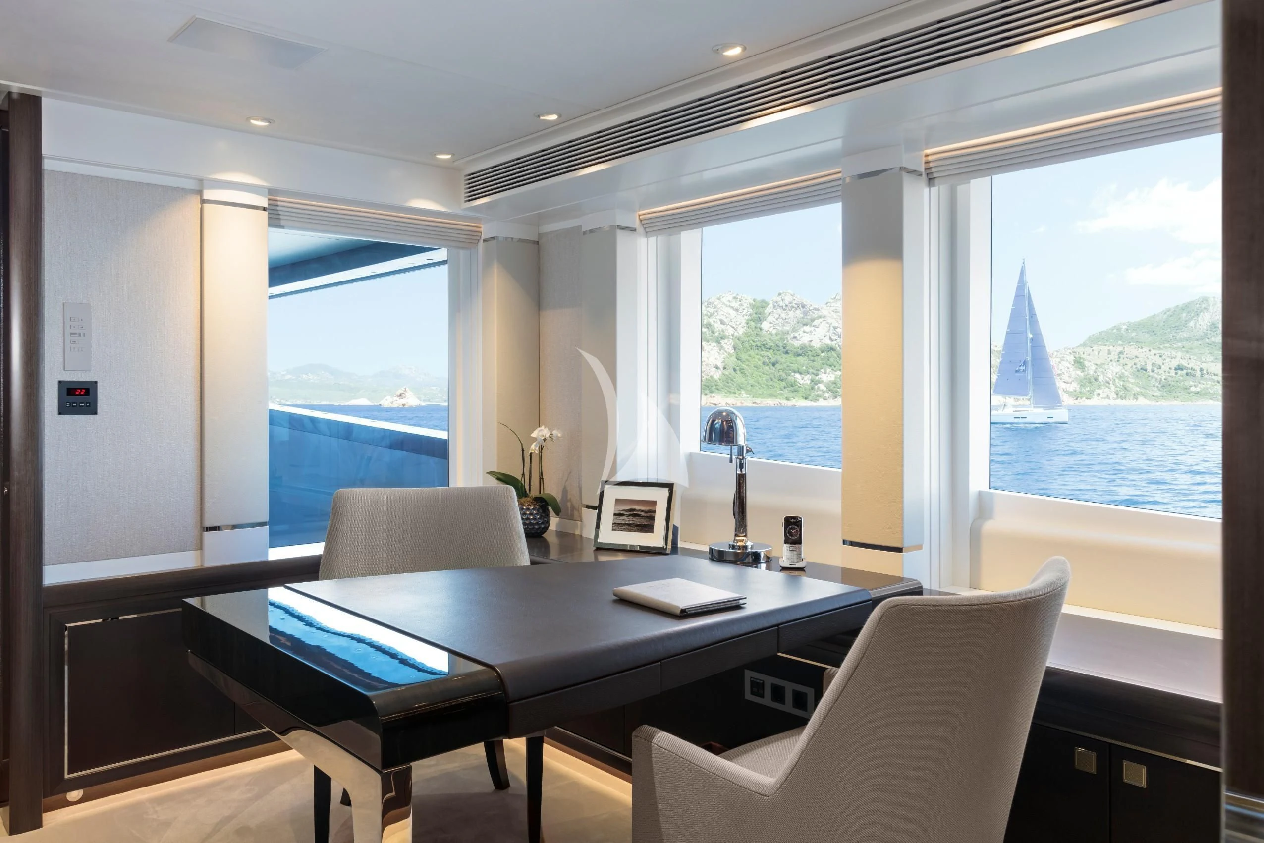 a room with a table and chairs aboard IRISHA Yacht for Sale